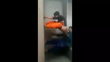 It looks like an amateur Indian couple is having sex on the wall